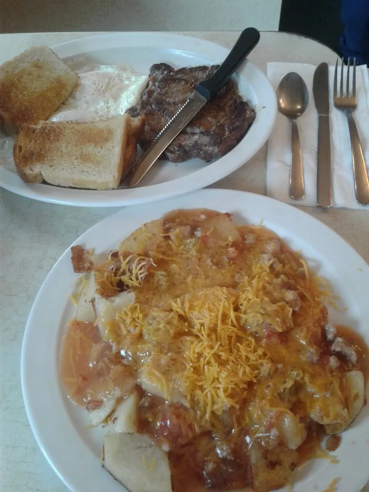 Steak and Eggs w Potatoes Smothered w Green Chili